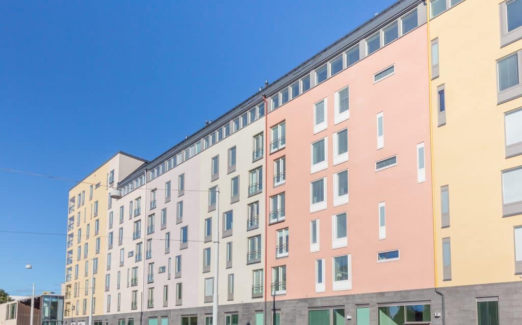 Precast concrete wall with colored concrete and untraditional window positioning. Building: Helsingin Emmy residential building.