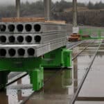 Automatic slab transportation in hollow core slab production at a precast plant