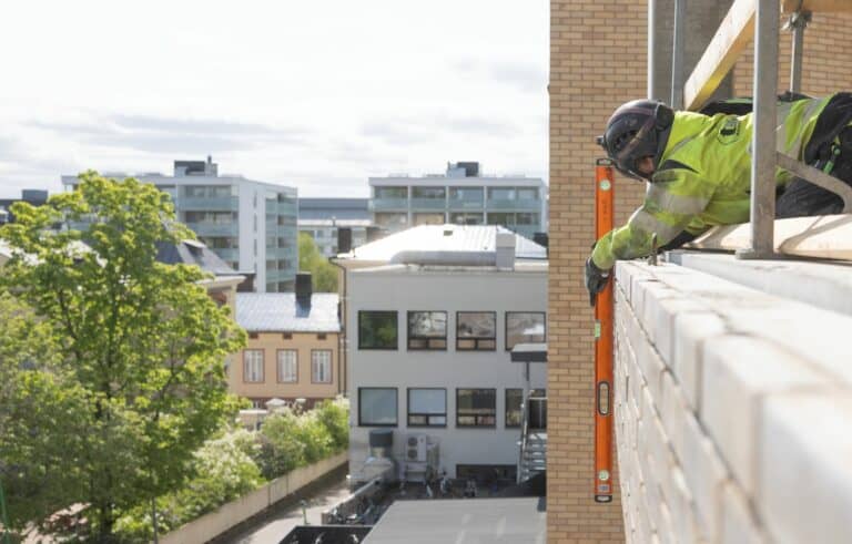 Installing a precast brick facade.