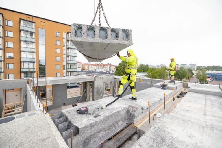 Installing a hollow core slab at a construction site.