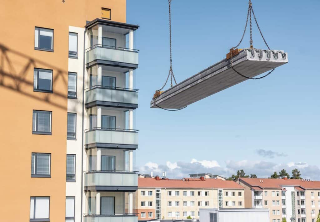 Installing a precast hollow core slab at a construction site.
